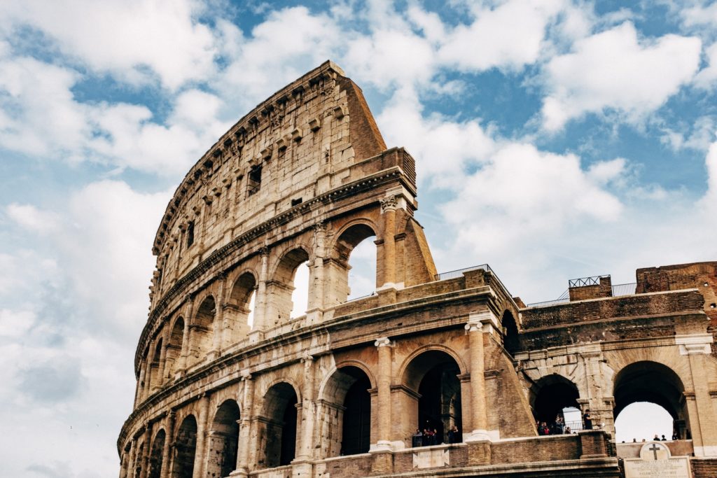 Colosseum under white clouds during daytime