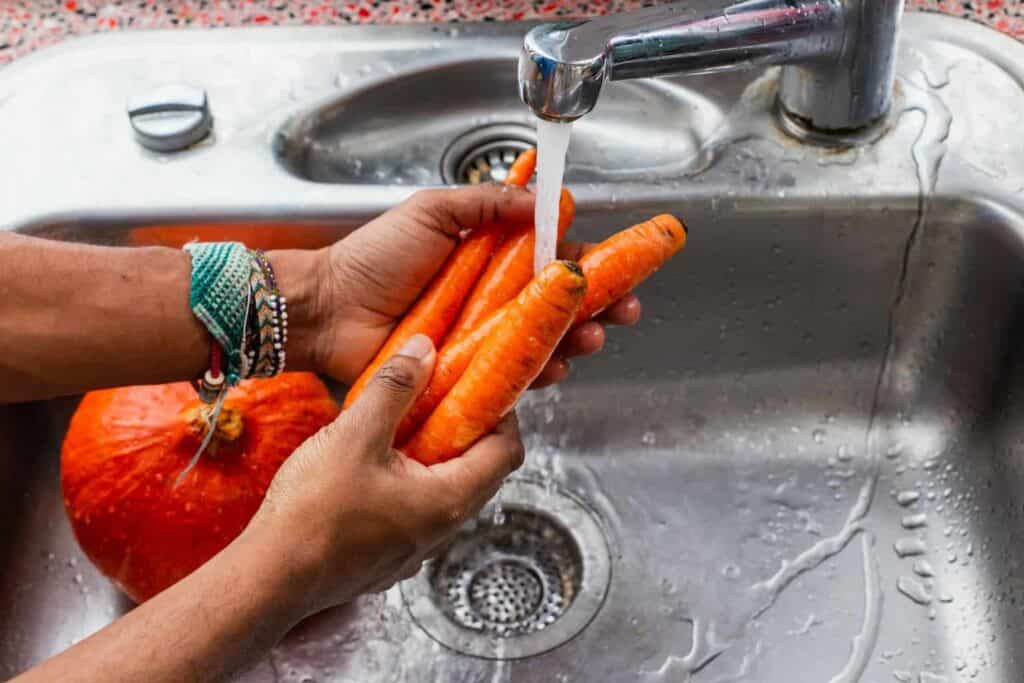 person washing carrots