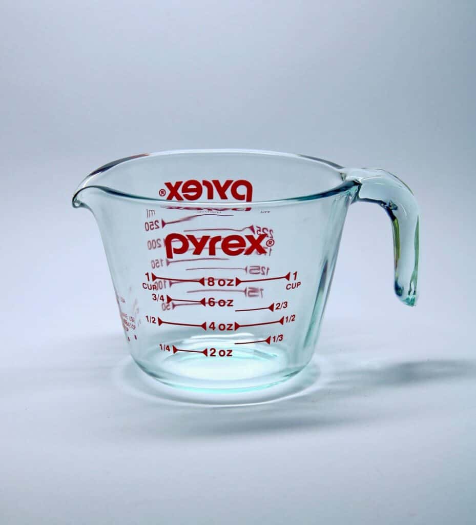 clear glass measuring cup on white surface