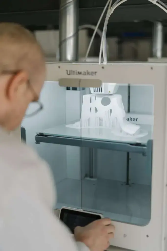 person in white shirt using sewing machine