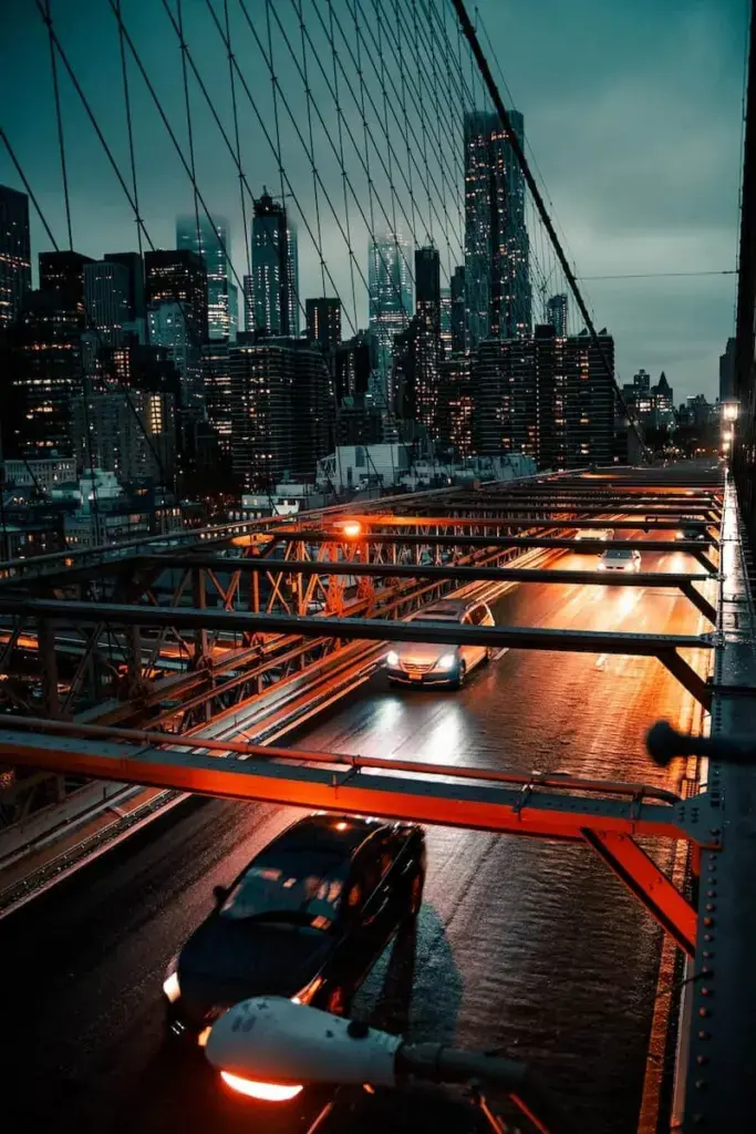 cars on road near city buildings during night time