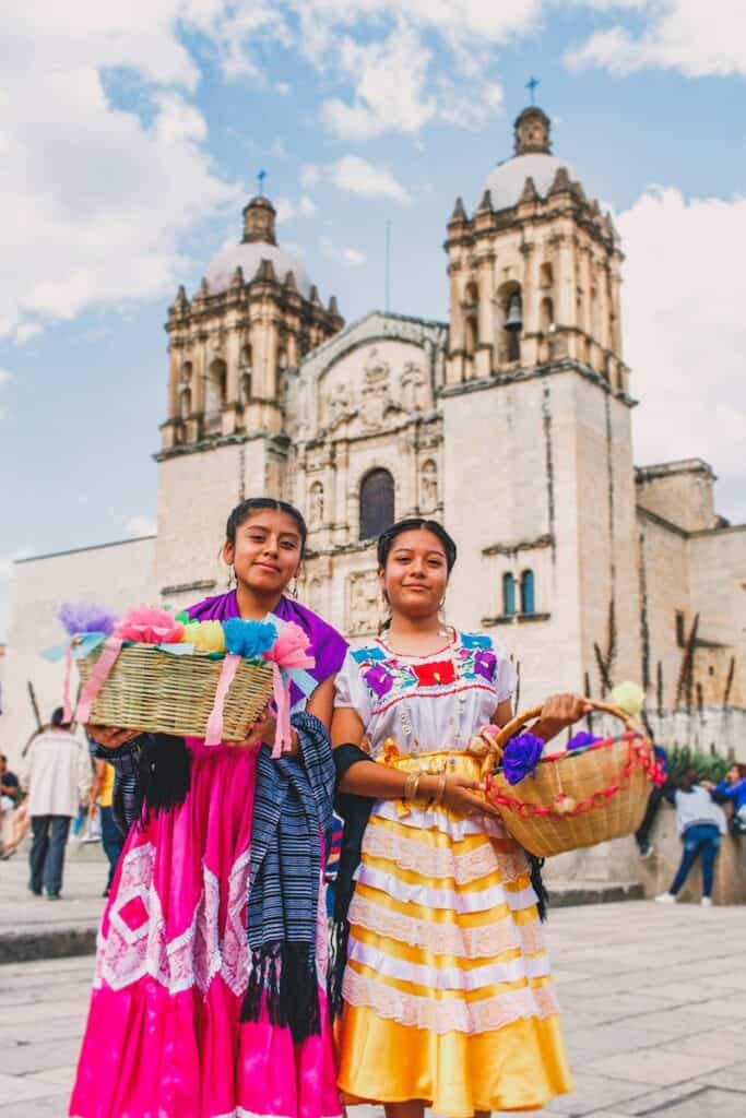 two woman carrying baskets