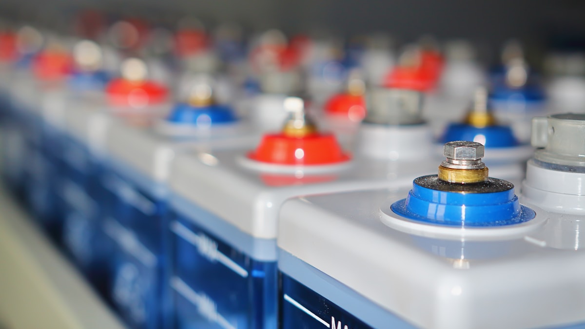Rows of large batteries with red and blue terminals